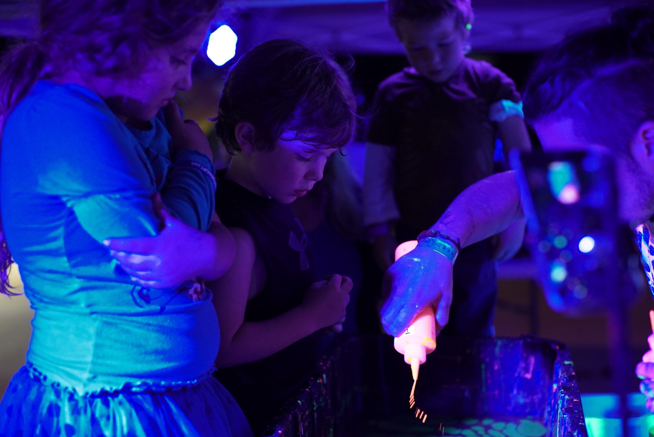 Participants creating Ebru under blacklight
