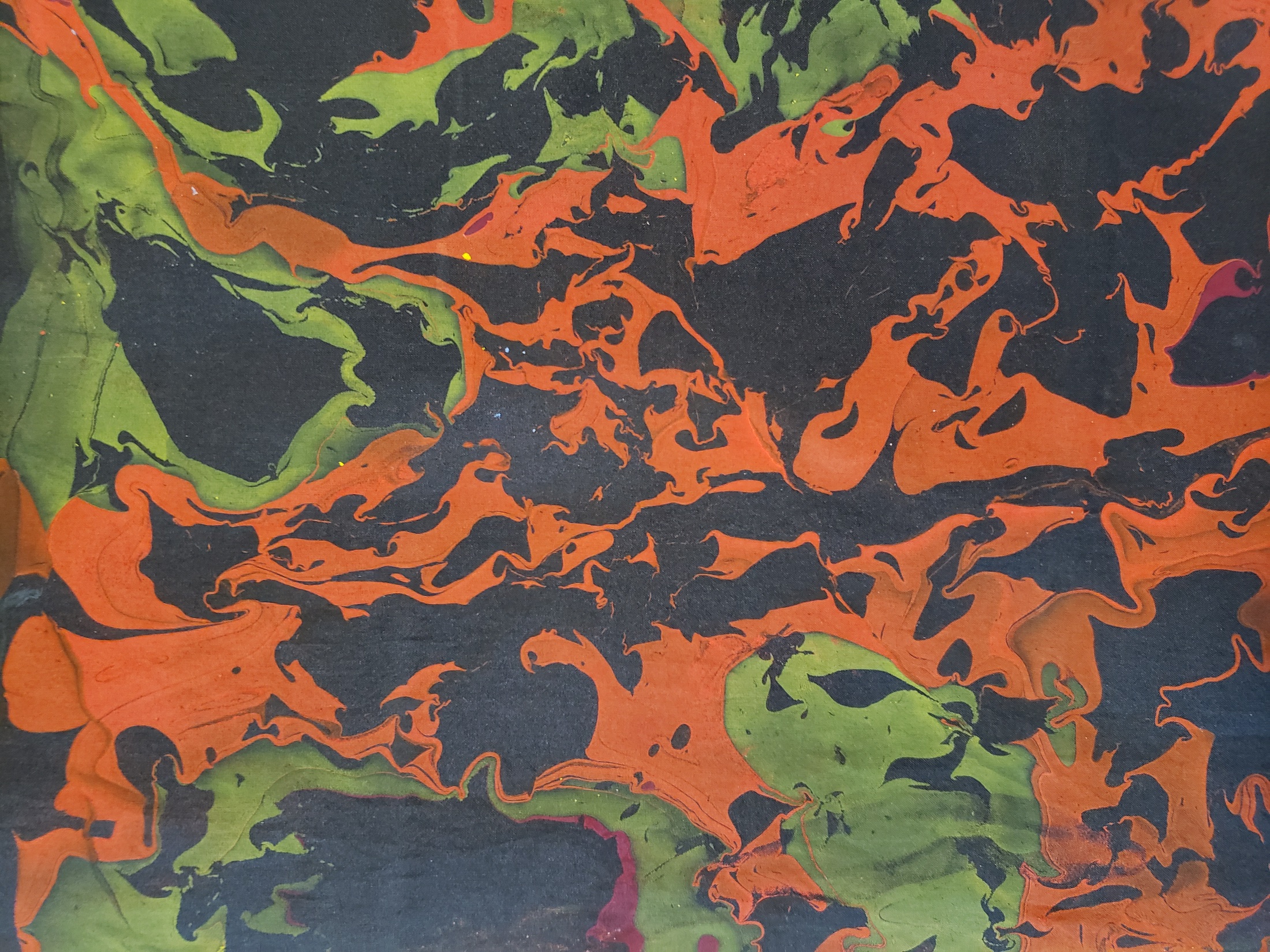 Orange and green marbling detail on silk